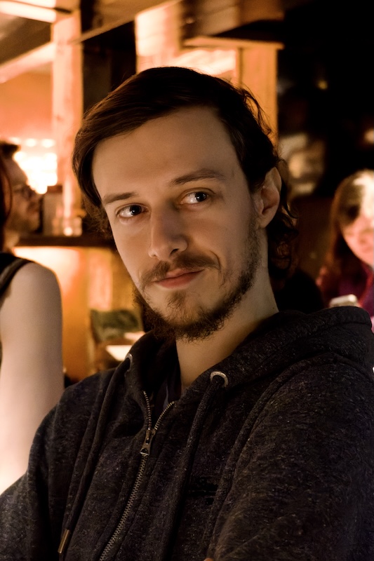 Portrait of a person looking just past the camera, the background is blurry